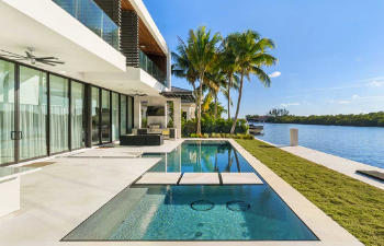 modern house with a swimming pool by a river