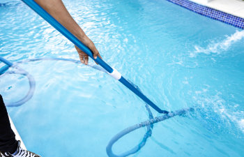 https://www.somarpools.com/wp-content/uploads/2023/03/pool-maintenance-and-cleaning-with-vacuum-hose.jpg