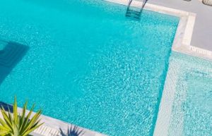 aerial view of a backyard swimming pool with clear water