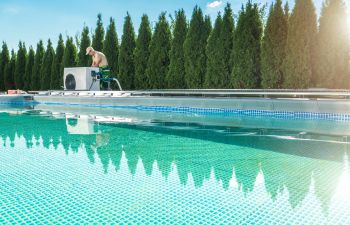 A technician maintaining swimming pool heating pump